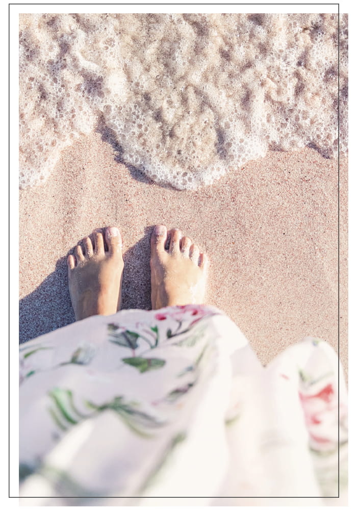 Image of feet on sandy beach
